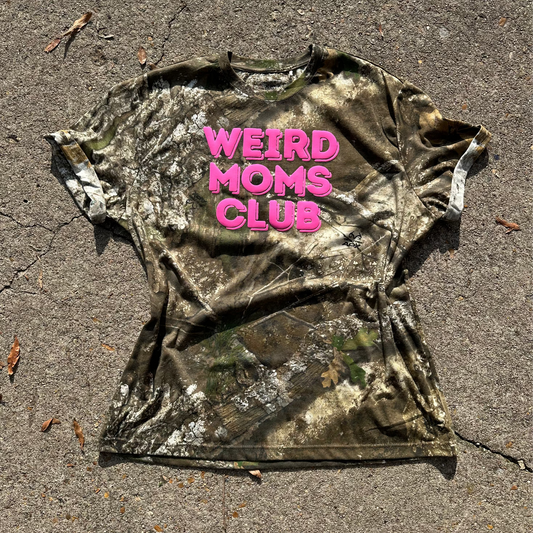 Camouflage t-shirt with 'WEIRD MOMS CLUB' text in pink 